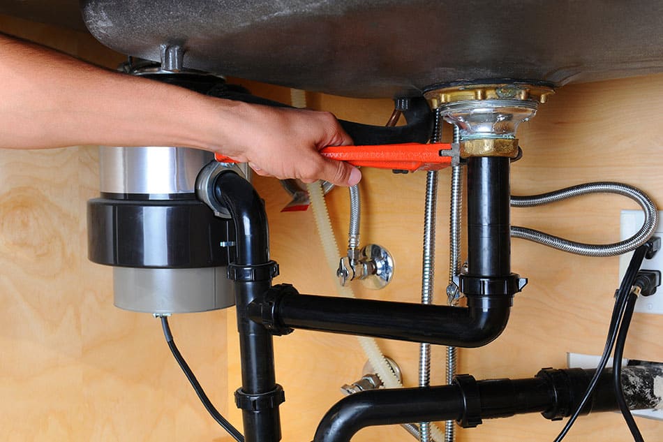 Homeowner working on plumbing drain