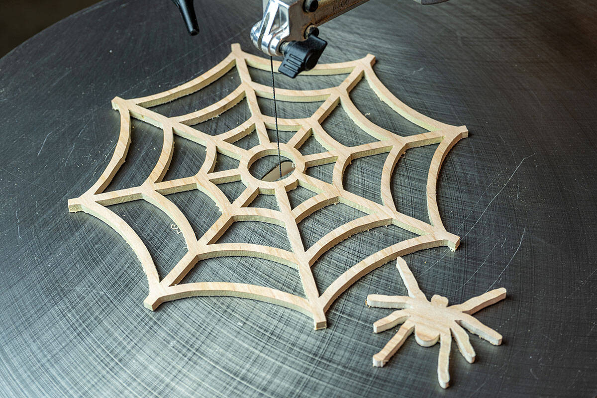 Scroll saw after cutting an intricate spider web